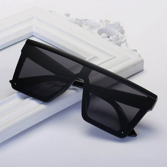 Sunglass Lover vintage black square oversized sunglasses flat top shield frame on white decorative background