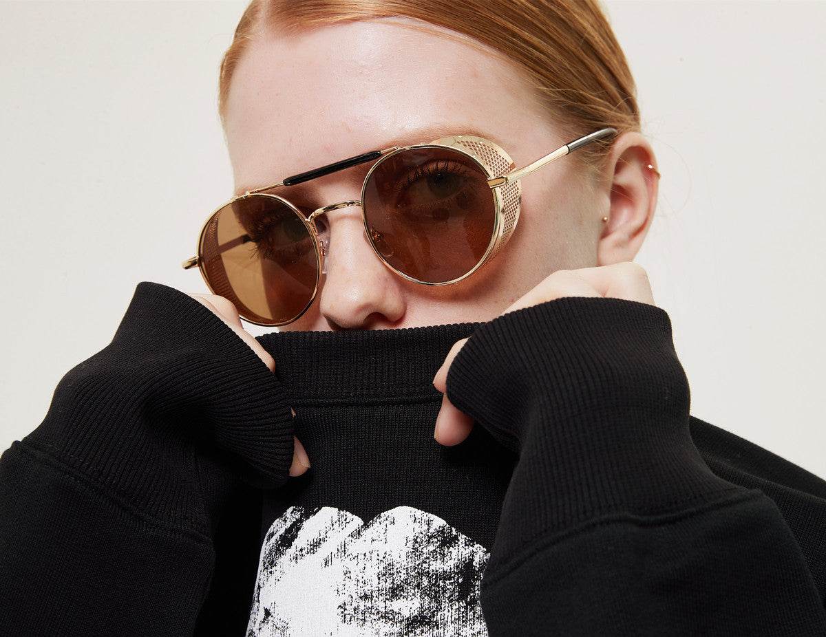 Sunglass Lover gold frame vintage round sunglasses for women with brown lenses and decorative bridge on model