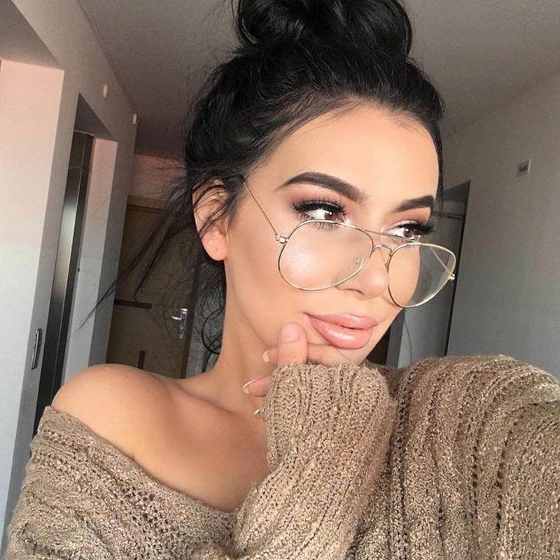Sunglass Lover aviation metal frame eyeglasses on woman with top knot and neutral makeup in cozy sweater