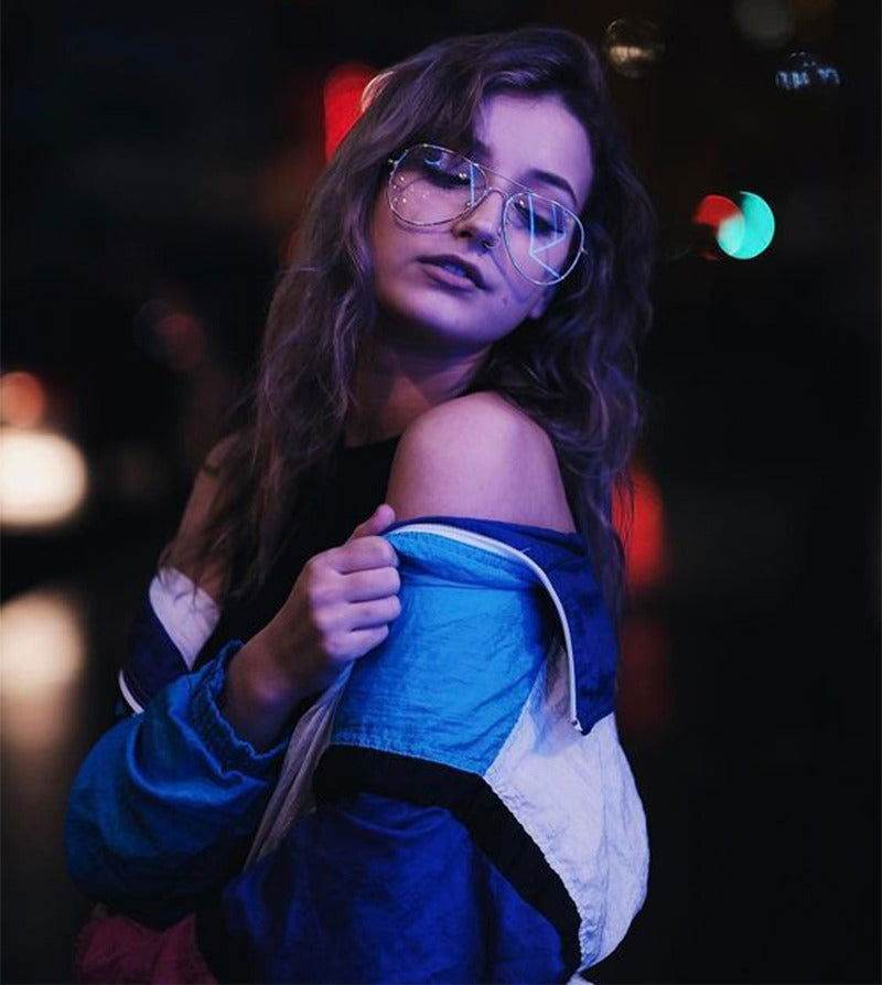 Sunglass Lover aviation metal frame eyeglasses on woman in retro jacket at night with city bokeh lights