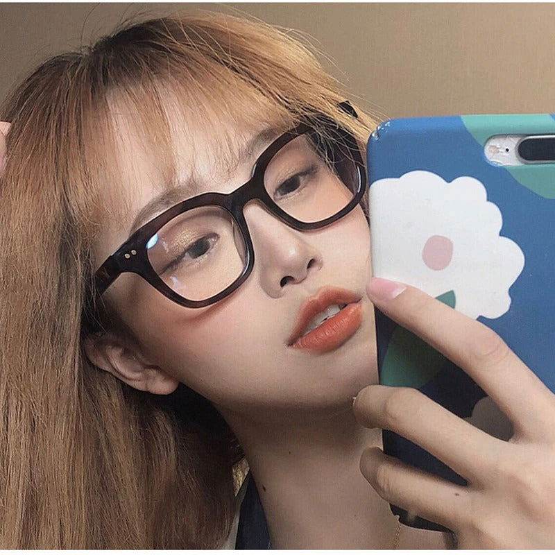 Sunglass Lover fashion rectangle sunglasses for women in dark tortoiseshell worn by model taking a selfie