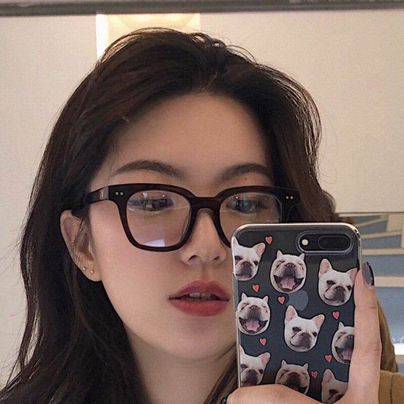 Sunglass Lover model wearing black acetate fashion rectangle sunglasses for women in mirror selfie