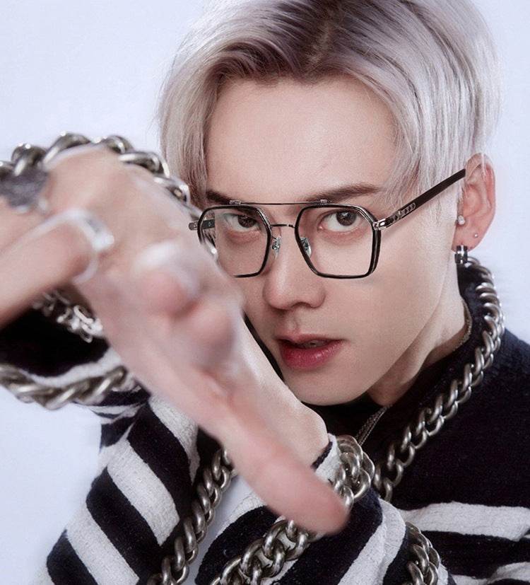 Sunglass Lover model wearing oversized square metal eyeglasses frames in black metal with chains and striped sweater