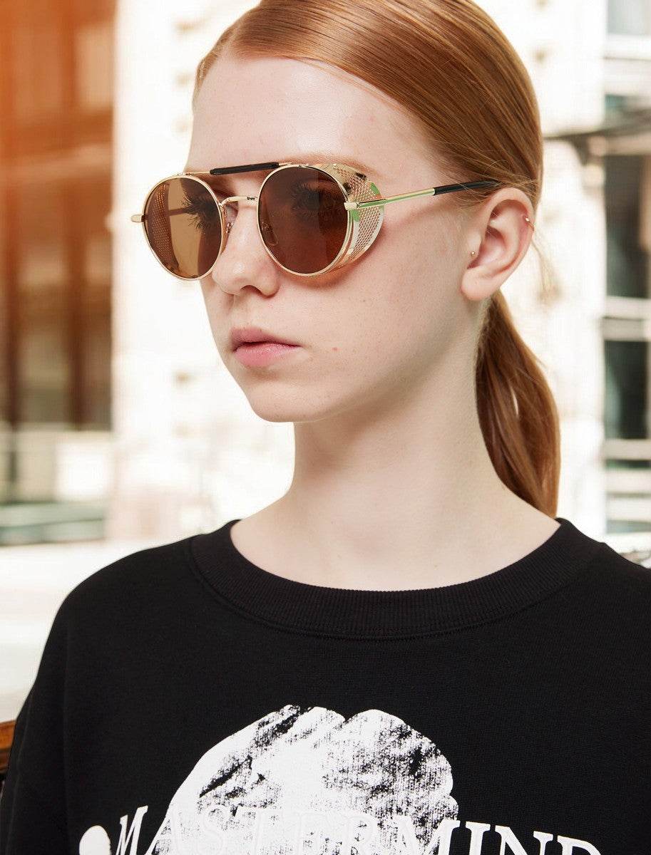 Sunglass Lover retro steampunk round sunglasses on model with gold metal frames brown mirrored lenses