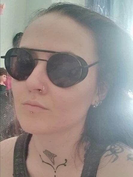 Sunglass Lover black retro vintage round sunglasses worn by woman with nose ring and small tattoo