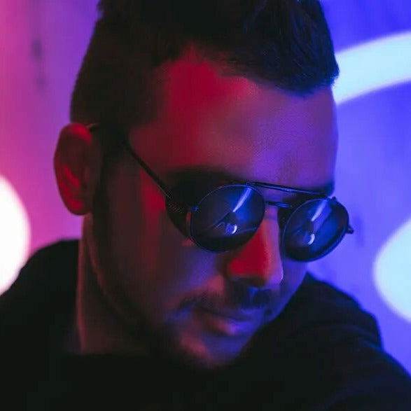 Sunglass Lover model wearing retro vintage round sunglasses in neon red and blue lighting