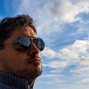 Sunglass Lover retro vintage round sunglasses on a man against blue sky ideal for outdoor style