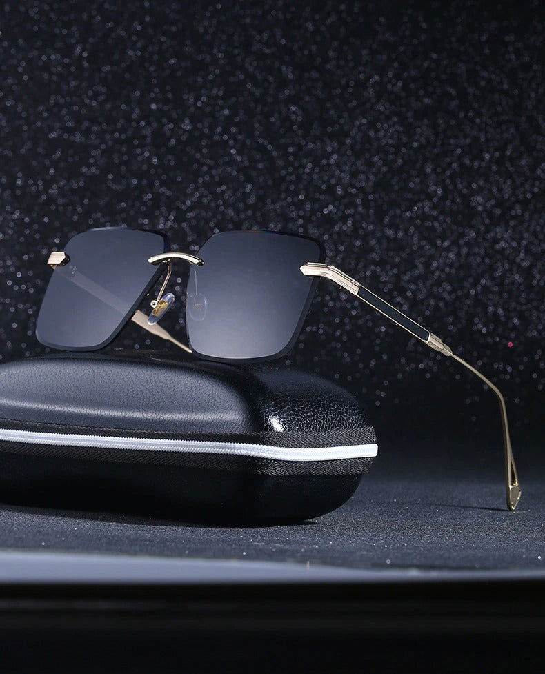 Sunglass Lover oversize square rimless sunglasses with black lenses and gold temples on a black case