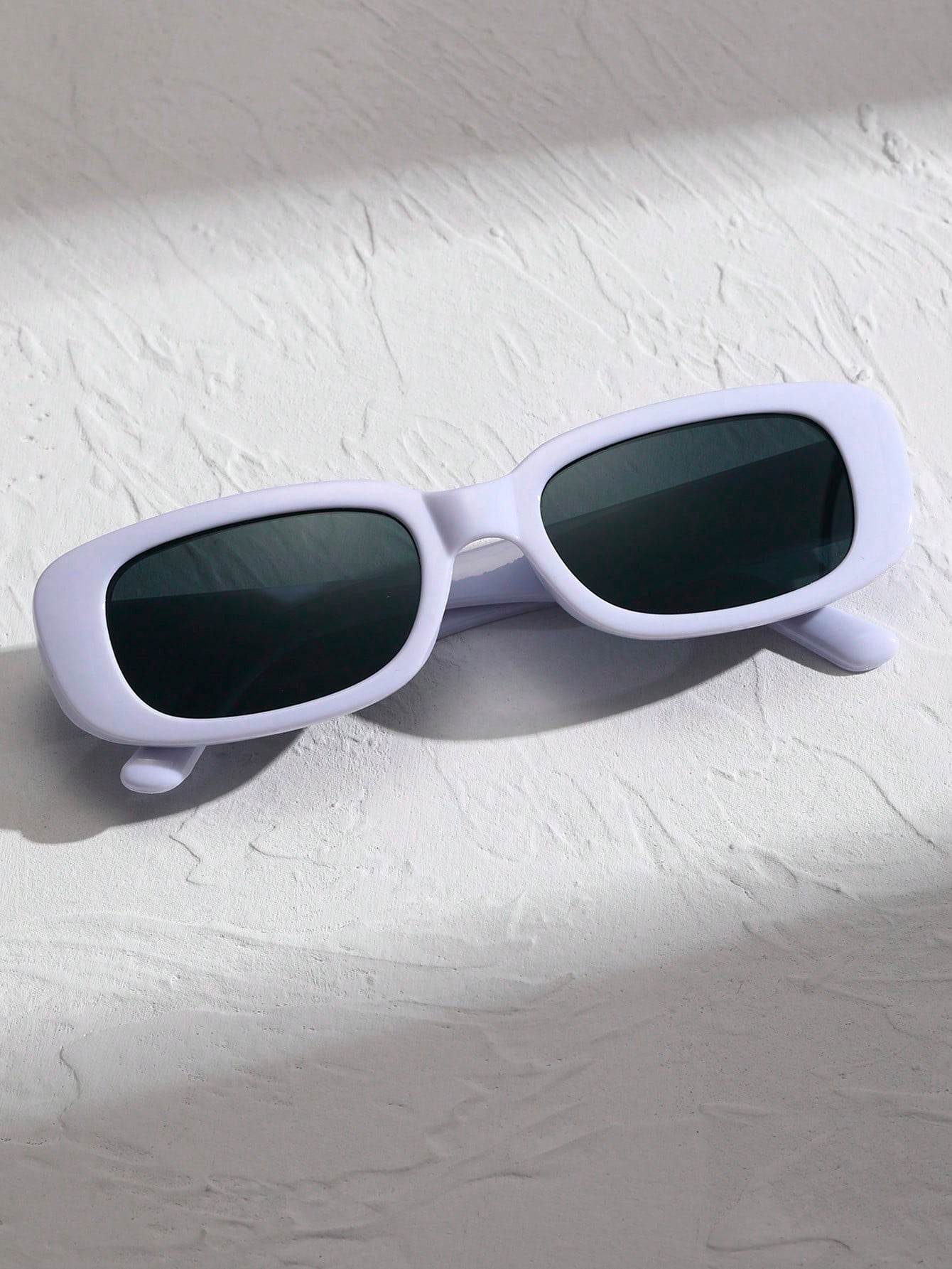 Sunglass Lover white small rectangle sunglasses with dark lenses on textured white surface in soft shadow