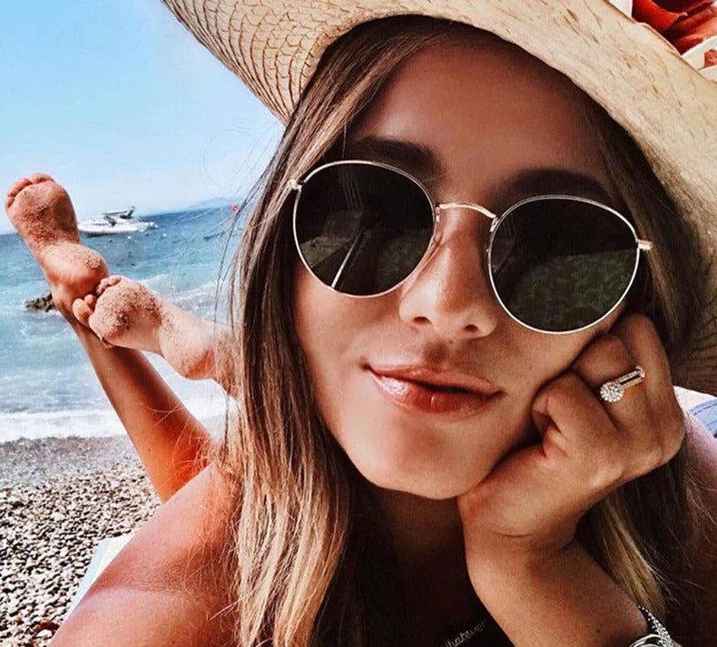 Sunglass Lover woman wearing round sunglasses for men and women, gold frame, beach hat