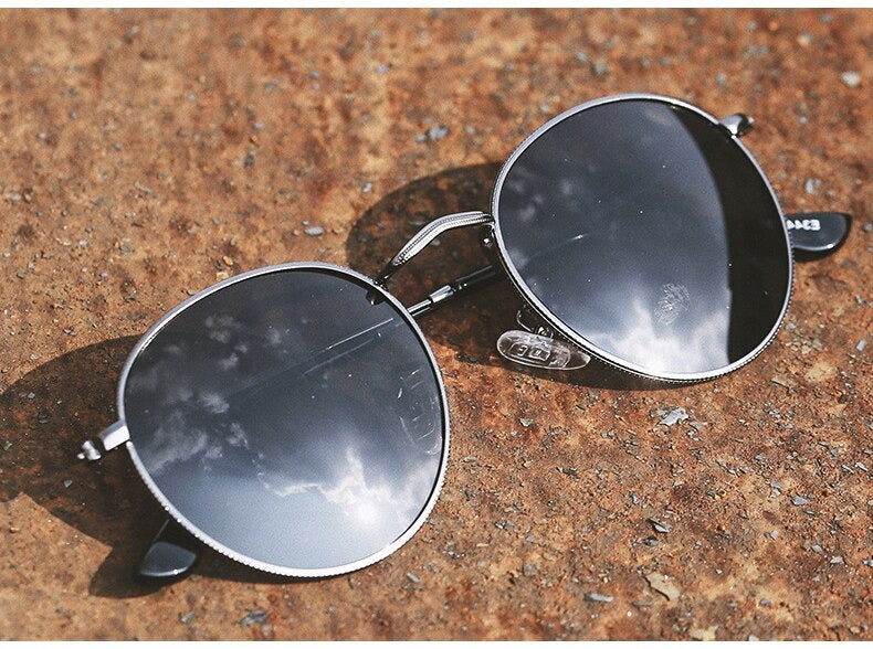 Sunglass Lover round sunglasses for men and women vintage silver metal frame with mirrored lenses on rust surface