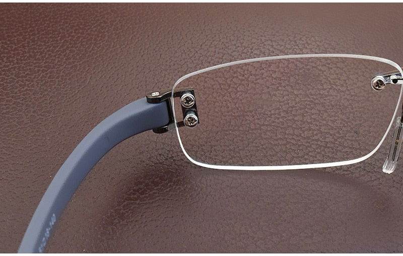 Sunglass Lover rimless eyeglasses close up showing lightweight rimless eyeglass frames with blue temple and metal hinge