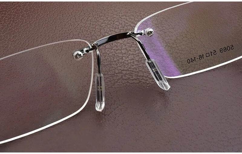 Sunglass Lover lightweight rimless eyeglass frames with chrome bridge and adjustable clear nose pads closeup