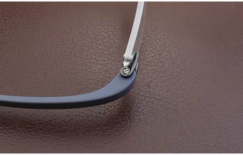 Sunglass Lover close up of lightweight rimless eyeglass frames hinge showing metal temple and blue tip