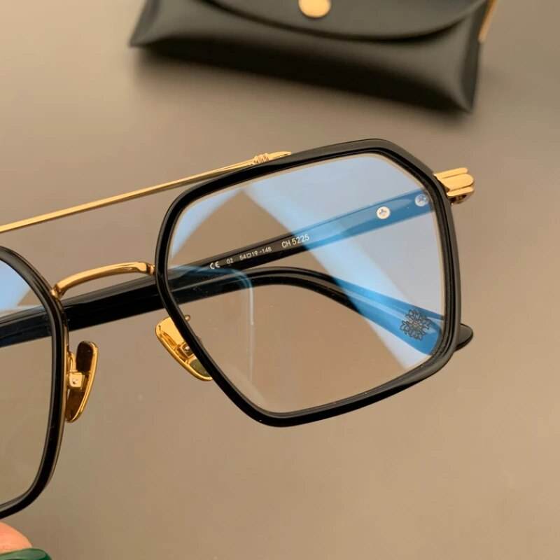 Sunglass Lover unisex hexagonal eyeglasses black frame with gold accents and blue tinted lenses close up