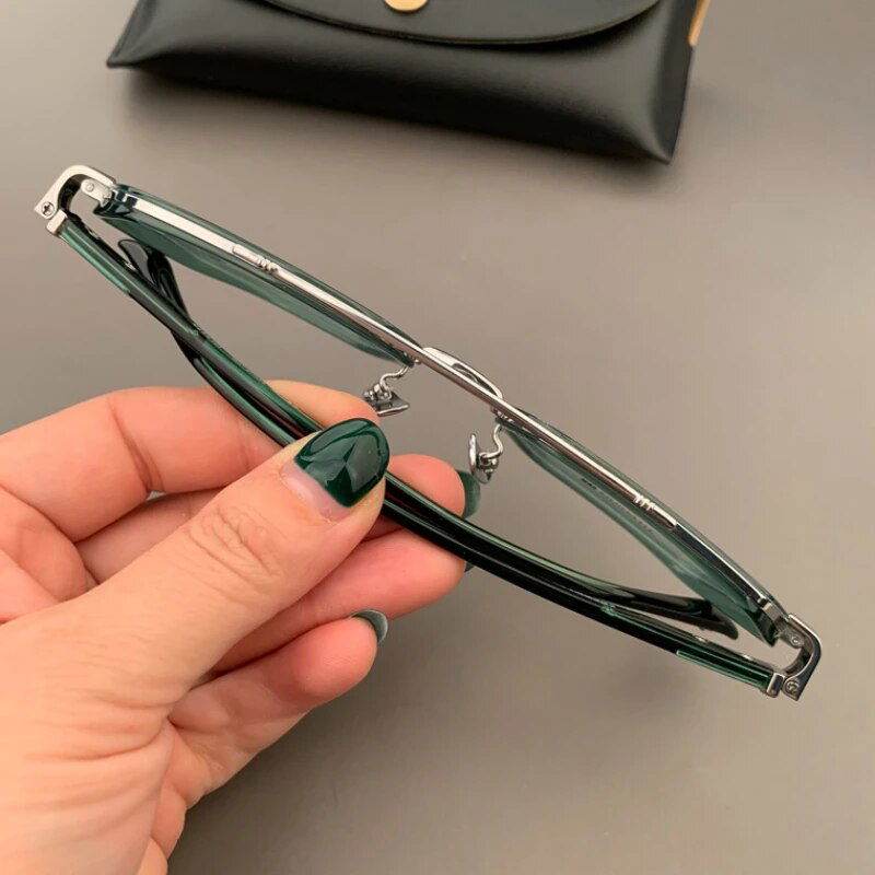 Sunglass Lover unisex hexagonal eyeglasses green translucent frame with metal bridge folded in hand