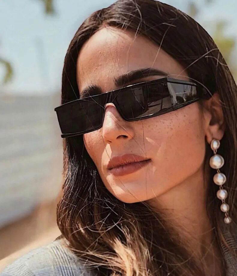 Sunglass Lover black retro rectangle sunglasses for women worn by model with pearl drop earrings outdoors