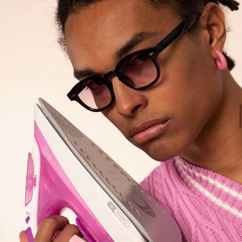 Sunglass Lover unisex vintage sunglasses online India black round frames on model wearing pink sweater holding pink iron