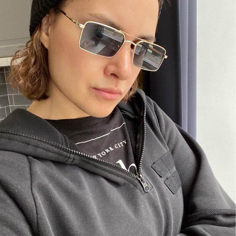 Sunglass Lover gold frame double bridge rectangle sunglasses worn by model with black beanie and hoodie