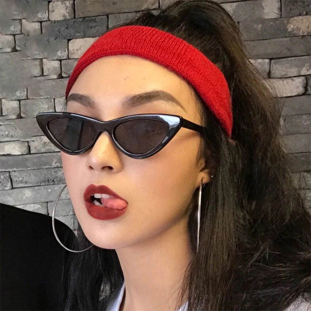 Sunglass Lover small cat eye sunglasses trendy black frames on woman with red headband and hoops