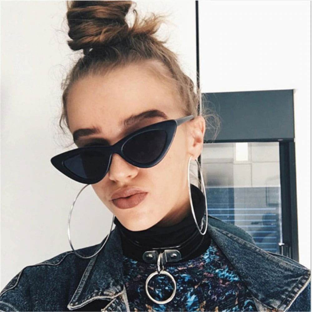 Sunglass Lover model wearing black small cat eye sunglasses trendy with top knot denim jacket