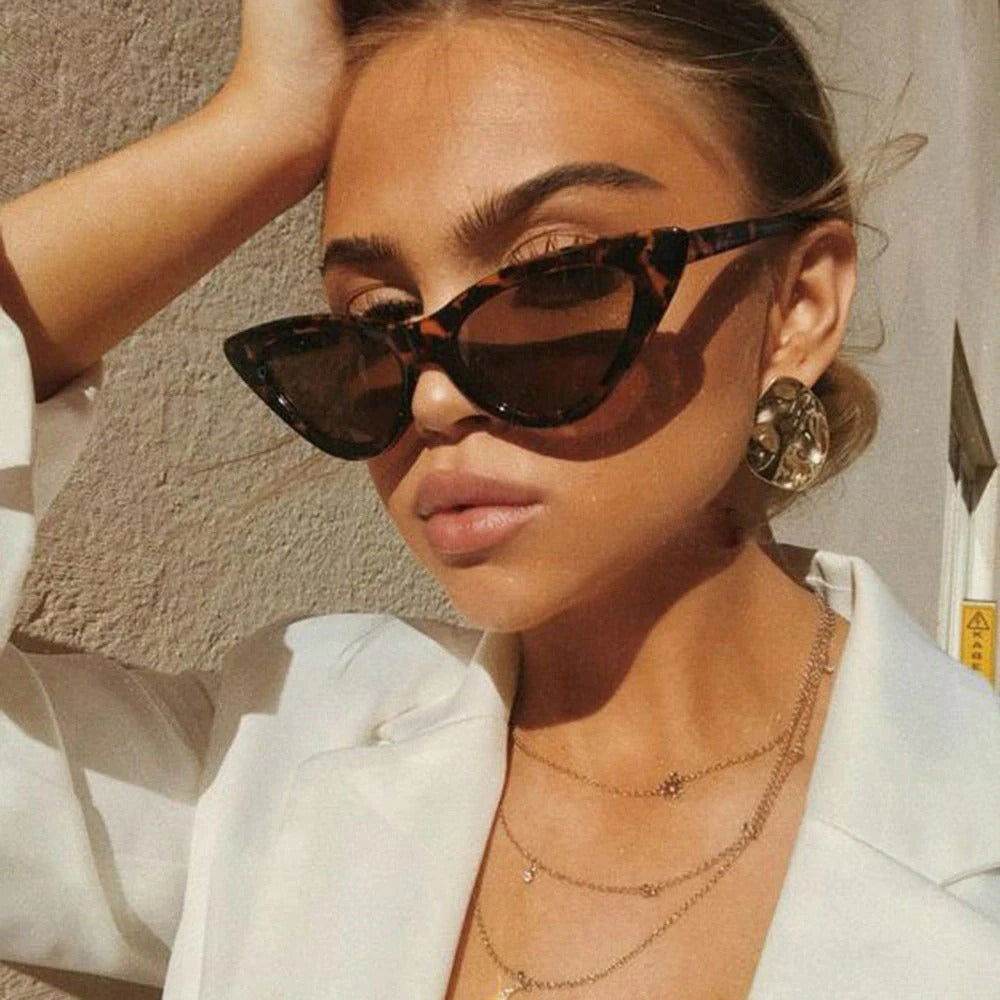 Sunglass Lover tortoiseshell small cat eye sunglasses trendy on woman wearing white blazer and gold jewelry
