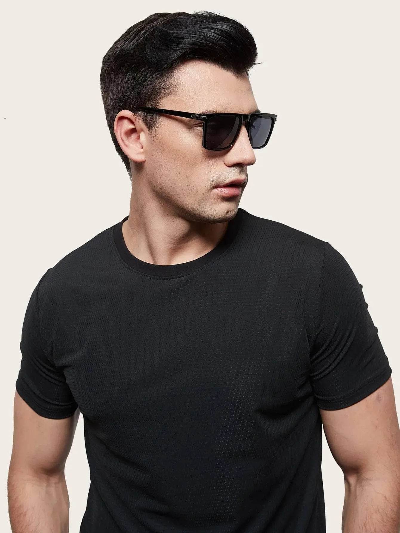 Sunglass Lover model wearing men's black square sunglasses with matte black frame and UV lenses
