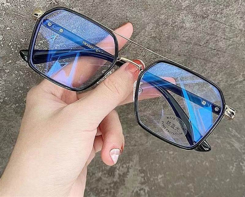 Sunglass Lover punk style blue light blocking eyeglasses metal square frame with blue tint held in hand