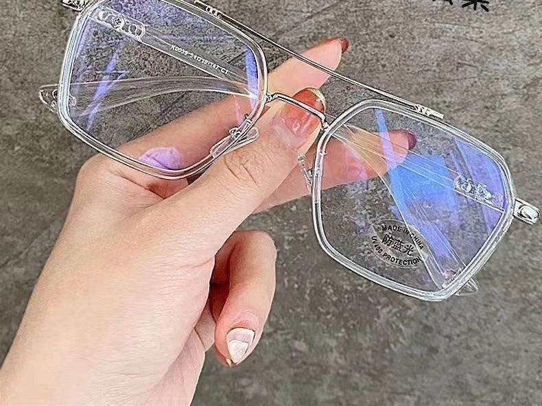 Sunglass Lover punk style blue light blocking eyeglasses clear oversized square frame held by hand