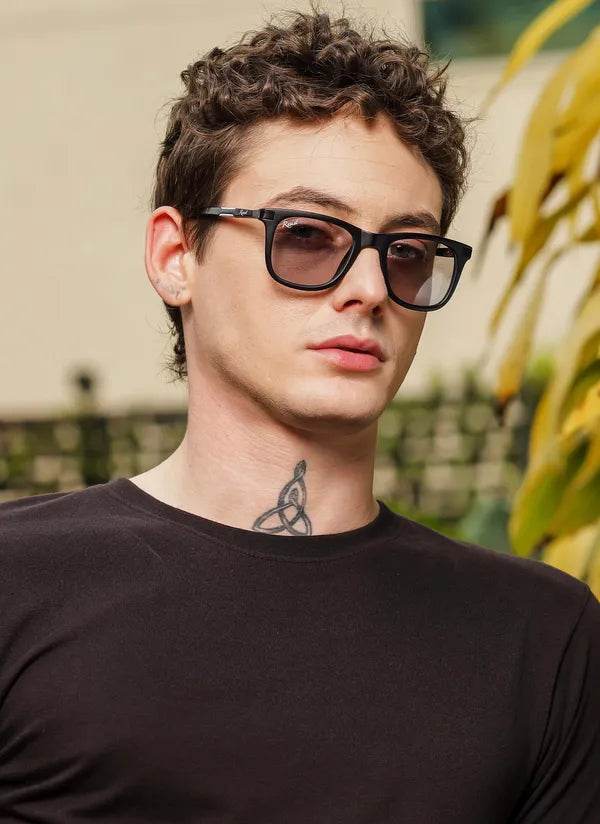 Sunglass Lover black wayfarer sunglasses on young man with curly hair neck tattoo UV protected photochromic glasses