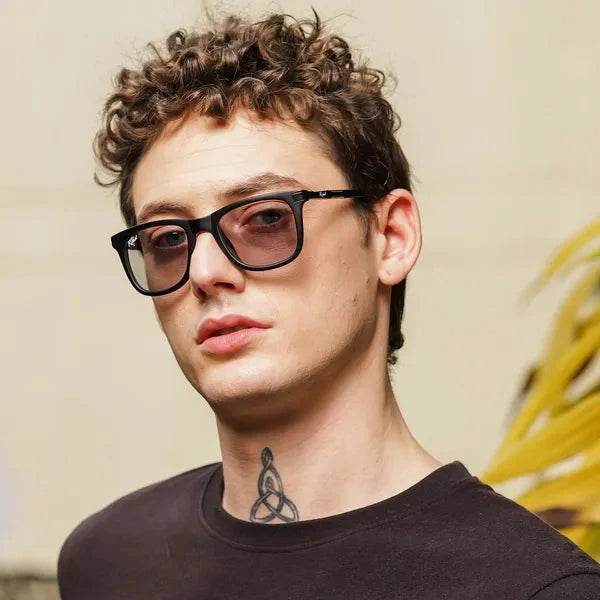 Sunglass Lover black wayfarer sunglasses on male model with curly hair wearing UV protected photochromic glasses