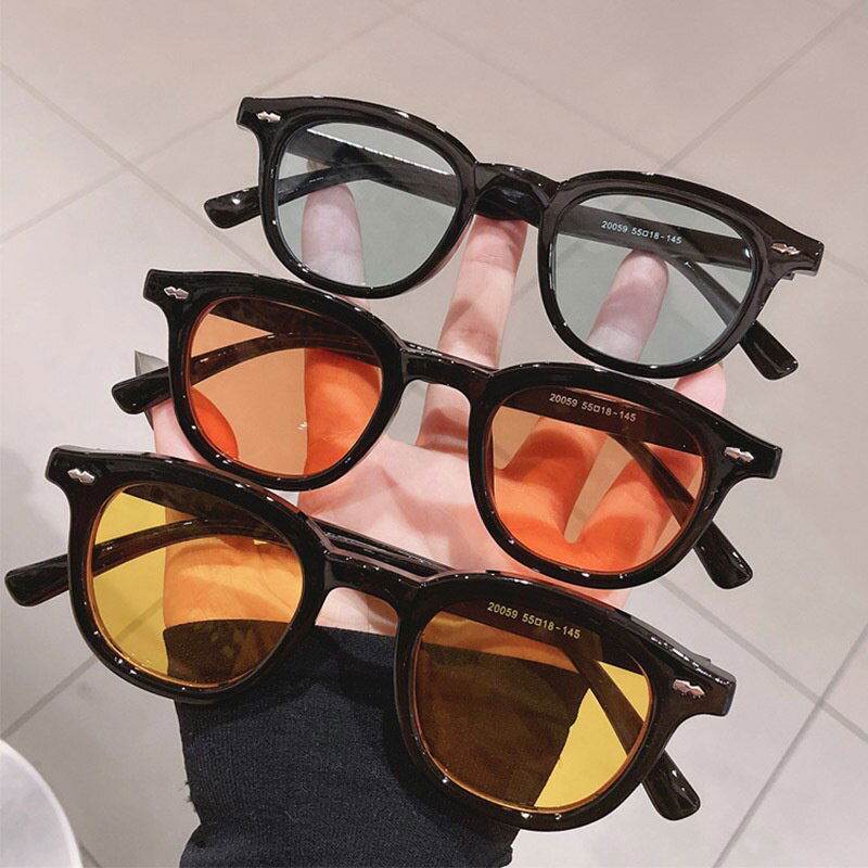 Sunglass Lover vintage round sunglasses for men and women black frames hand holding four pairs with assorted lenses