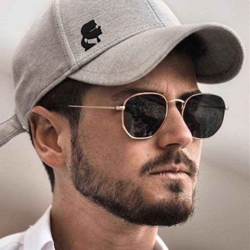 Sunglass Lover hexagon vintage sunglasses on bearded man wearing gray cap with gold thin metal frame