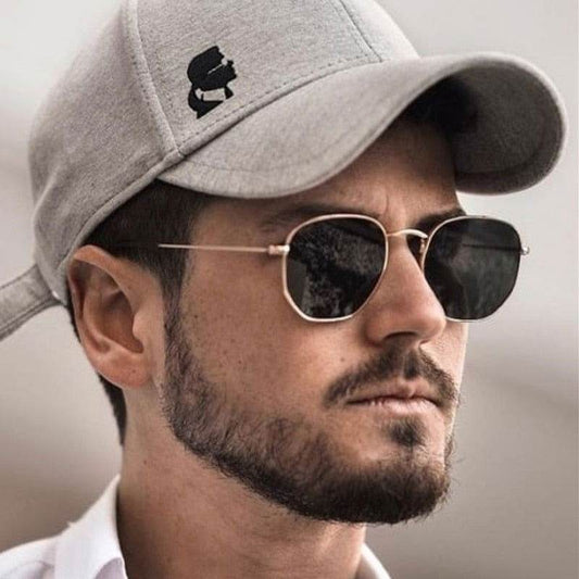 Sunglass Lover hexagon vintage sunglasses on bearded man wearing gray cap with gold thin metal frame