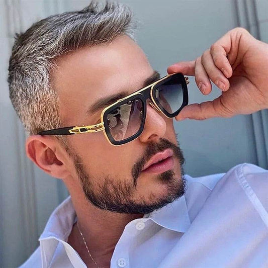 Sunglass Lover model wearing retro men's square sunglasses in black and gold with gradient lenses