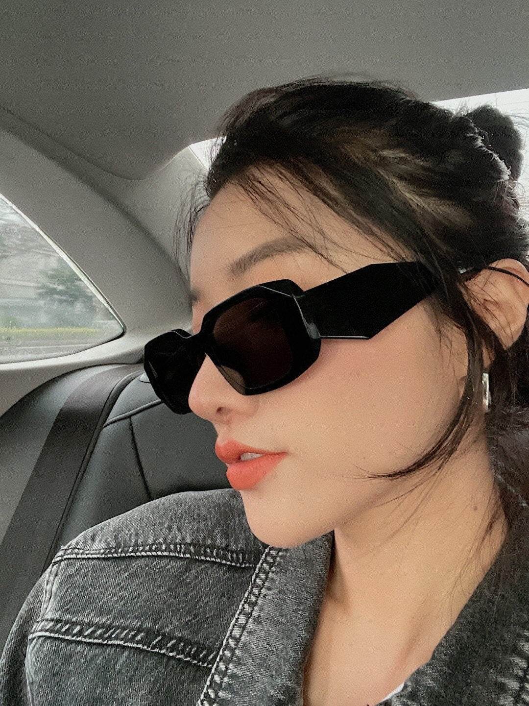 Sunglass Lover black geometric narrow frame sunglasses for women worn by model in denim jacket side profile