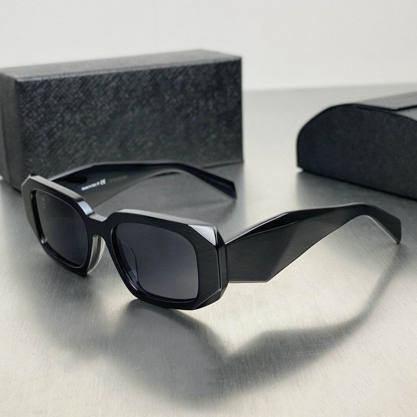 Sunglass Lover black geometric sunglasses on metal table with case and box narrow frame sunglasses for women
